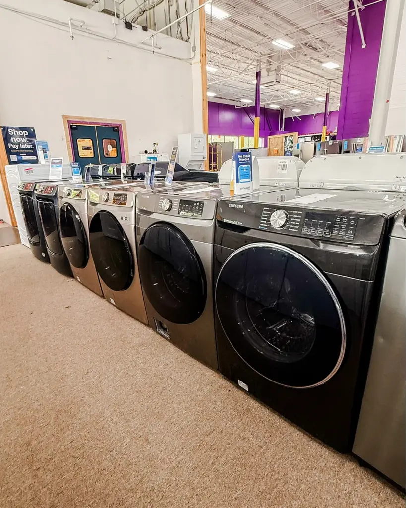 Front load washers and dryers with shop now pay later sign at Compare Deals