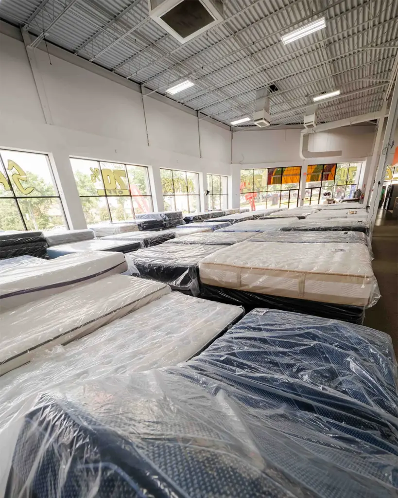 Wrapped discount mattresses on the floor at Compare Deals mattress outlet