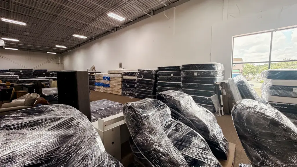 Wrapped mattresses and box springs in Compare Deals warehouse