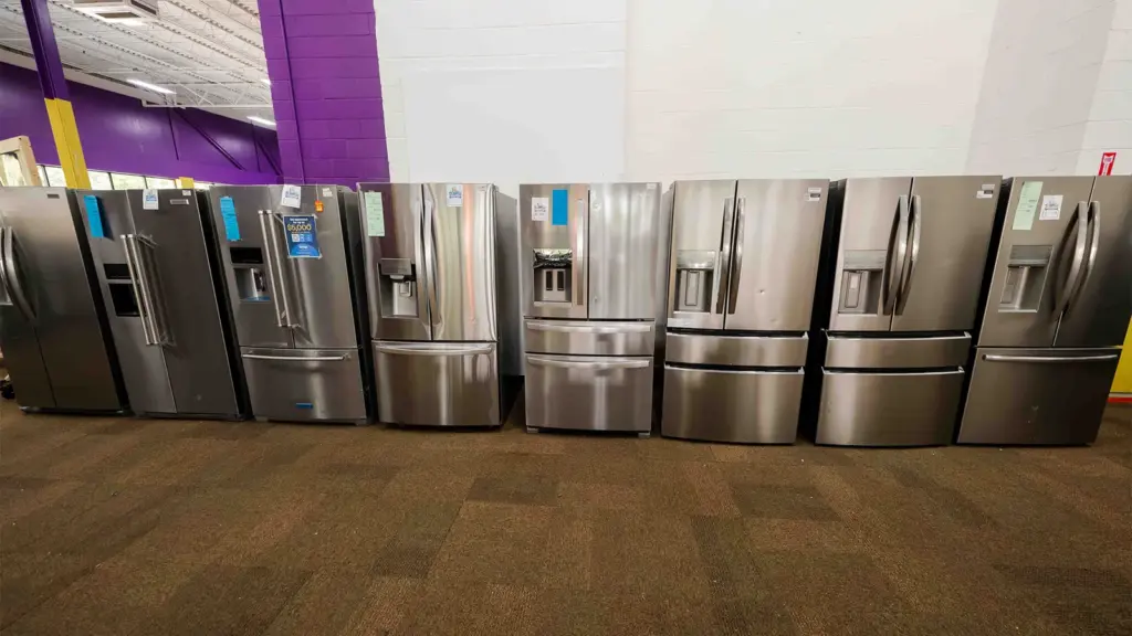 Lineup of stainless French door refrigerators at Compare Deals appliance outlet